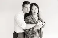 A man hugs a woman from behind