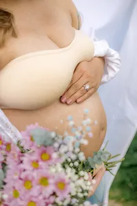 Close up of a pregnant belly with flowers