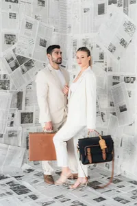 A couple poses with briefcases