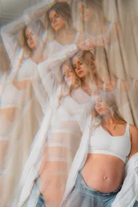 A woman poses in front of a sheet