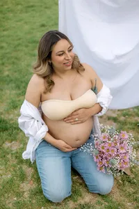 A pregnant woman is happy while holding her belly