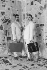 A couple poses with briefcases