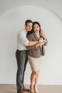 A man hugs a woman from behind