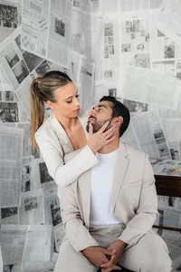 Two people lean in for a kiss