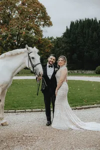 Bride and groom with white horse