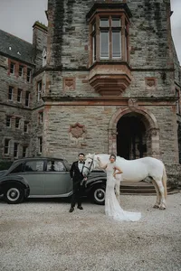 Ireland castle with bride and groom in front with horse and car