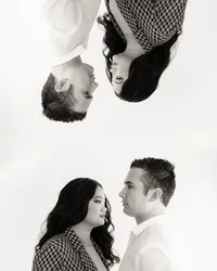 Two people look towards each other