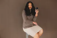 A woman holds her phone