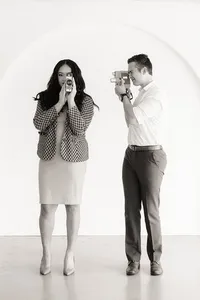 Two people hold cameras