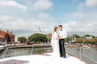 Bride and groom on boat looking into each other's eyes