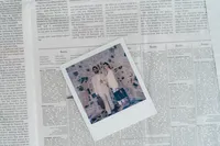 A polaroid on a newspaper