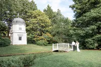 Bride and groom walking across bridge