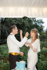 Bride and groom tasting wedding cake