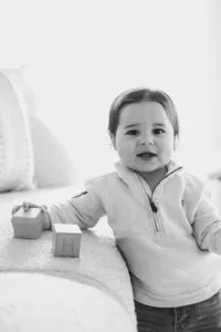 A child holds blocks