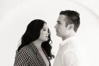 Two people look towards each other