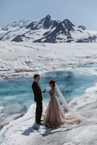 Bride and groom exchange private vows beside a brilliant blue meltwater pool on a remote Alaska glacier.