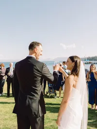 bride and groom cheering champagne to their guests