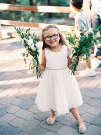 flower girl at wedding reception holding flowers