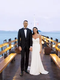 bride and groom on the pier during alpine glow