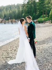 bride and groom portraits looking at each other on the beach in Lake Tahoe
