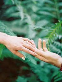 Bride and groom hand touching