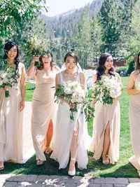 bride is walking with her bridesmaids dressed in pink