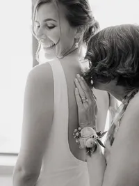 mother kissing her daughters brides back