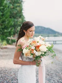 film photo of bride holding huge bouquet on Lake Tahoe beach