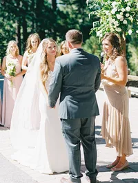 film photo of bride smiling at groom during the ceremony