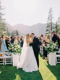 Bride and groom kissing just after the ceremony walk at Everline Resort Tahoe