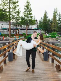 groom carrying bride on Gar Woods per