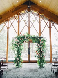 wedding arch at Edgewood wedding reception hall with huge windows in the background