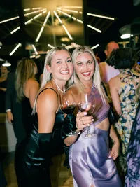 epic photo of lights during wedding reception and guests posing for a photo