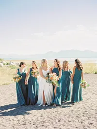 bride and bridesmaids laughing and walking on the beach in Lake Tahoe