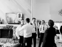 groomsmen getting ready by putting on ties