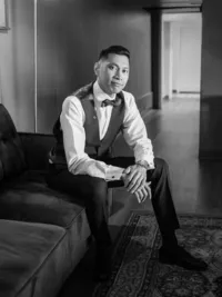 black and white groom portrait sitting on the couch