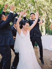 bride dancing with groomsmen