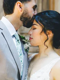 groom kissing bride on the forehead