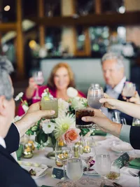guests cheering with cocktails at the Edgewood wedding reception