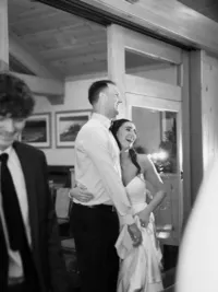 bride and groom hugging and laughing during their wedding reception