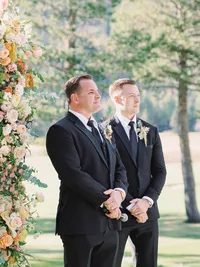 groom is looking at the bride walk down the isle at everline resort tahoe wedding