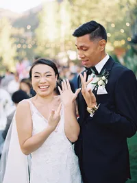 Just married photo of bride and groom showing their rings