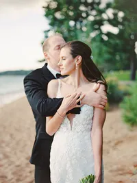 film photo of bride and groom embracing on the beach