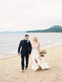 bride and groom on windy lake Tahoe beach