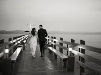 bride and groom running on Gar Woods dock during the sunset