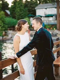 film photo of groom looking at the bride on the pier