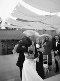 father embraces bride after he walked her down the isle