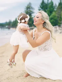 bride picking up her daughter flower girl after the wedding at The landing resort tahoe