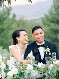 bride and groom laughing during the speech part of their wedding