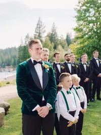 groom on the beach looking at the bride walking down the isle